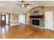 Spacious living room with a stone fireplace, hardwood floors, and neutral paint colors at 2420 New Bethel Church Rd, Garner, NC 27529