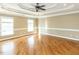 Spacious main bedroom with tray ceilings, hardwood floors, and ample natural light from large windows at 2420 New Bethel Church Rd, Garner, NC 27529