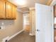 Hallway with washer/dryer hookups and neutral-colored walls and floors at 2420 New Bethel Church Rd, Garner, NC 27529