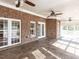 Sunroom featuring brick walls, tile floors, white trim, and abundant natural light at 2420 New Bethel Church Rd, Garner, NC 27529