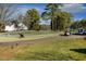 Picturesque golf course view with golfers, golf carts, lush green grass, and mature trees on a sunny day at 2949 Tillinghast Trl, Raleigh, NC 27613