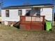 View of back of home with white siding and a wooden porch deck at 305 N State St, Raleigh, NC 27601