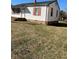 Angled front view of home with white siding, red shutters, and a well-maintained front yard at 305 N State St, Raleigh, NC 27601