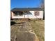 Charming single-story home with white siding, red shutters, and a well-maintained front yard at 305 N State St, Raleigh, NC 27601