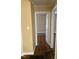 Hallway with hardwood flooring and doorways leading to other rooms in the house at 305 N State St, Raleigh, NC 27601