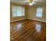 Living room with hardwood floors, neutral paint, and ample windows for natural light at 305 N State St, Raleigh, NC 27601