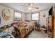 This bedroom features a ceiling fan, two windows, and neutral wallpaper at 372 Pocomoke Rd, Franklinton, NC 27525