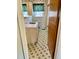 Bathroom with green and white tile and floral wallpaper at 405 N Wilson Ave, Dunn, NC 28334