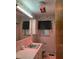 Retro bathroom featuring floral wallpaper, vintage fixtures, and accent lighting at 405 N Wilson Ave, Dunn, NC 28334