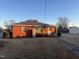 Red brick house with a covered porch and a well-maintained lawn at 405 N Wilson Ave, Dunn, NC 28334
