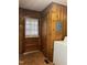 Laundry room with wood paneling, window, and door at 405 N Wilson Ave, Dunn, NC 28334
