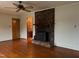Living room featuring hardwood floors and brick fireplace at 405 N Wilson Ave, Dunn, NC 28334