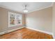 Bedroom with hardwood floors, crown molding, a modern ceiling fan, and a large window with neighborhood view at 421 Chapel Hill Rd, Burlington, NC 27215