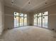 Bright room features natural light from two walls with multiple windows and taped walls at 436 Oakland Dr, Raleigh, NC 27609