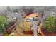 Aerial shot of the property showcasing the home's layout, long driveway, and surrounding wooded landscape at 4383 Deep River Rd, Sanford, NC 27330