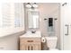 Bathroom with bright window, vanity with storage, and shower with updated fixtures at 4383 Deep River Rd, Sanford, NC 27330