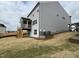 Exterior of a home with a deck, lawn, and gray siding on an overcast day at 4404 Emeline Way # 35, Fuquay Varina, NC 27526