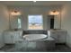 Luxurious bathroom with a large soaking tub, double vanities, and a bright window at 4404 Emeline Way # 35, Fuquay Varina, NC 27526