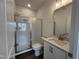 Bathroom featuring tile shower with glass door, modern vanity, granite countertop and tile floors at 4404 Emeline Way # 35, Fuquay Varina, NC 27526