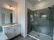 Modern bathroom featuring a glass shower, granite countertops, and modern light fixture at 4404 Emeline Way # 35, Fuquay Varina, NC 27526