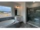 Bright bathroom featuring a glass-enclosed shower, modern vanity, and a luxurious soaking tub at 4404 Emeline Way # 35, Fuquay Varina, NC 27526