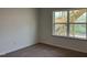 Bedroom features a window with a view of the backyard, as well as neutral walls and plush carpeted floors at 4404 Emeline Way # 35, Fuquay Varina, NC 27526