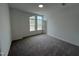 A carpeted bedroom with three windows allowing natural light at 4404 Emeline Way # 35, Fuquay Varina, NC 27526