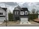 Two-story home exterior featuring stone accents, a two-car garage, and a well-manicured lawn at 4404 Emeline Way # 35, Fuquay Varina, NC 27526