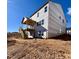 Back view of a new construction home with a wooden porch and staircase leading down to the yard at 4404 Emeline Way # 35, Fuquay Varina, NC 27526