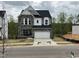 Charming two-story home with stone accents and a well-manicured front yard and attached two car garage at 4404 Emeline Way # 35, Fuquay Varina, NC 27526