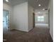 Open living area with plush carpeting, recessed lighting, and a seamless flow into adjacent rooms at 4404 Emeline Way # 35, Fuquay Varina, NC 27526