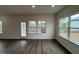 Living room with hardwood floors, lots of natural light, and access to a screened porch at 4404 Emeline Way # 35, Fuquay Varina, NC 27526