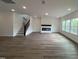 Spacious living room with a fireplace, staircase, hardwood floors, and lots of natural light at 4404 Emeline Way # 35, Fuquay Varina, NC 27526
