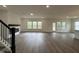 Large living room with a fireplace, hardwood floors, lots of natural light, and a staircase at 4404 Emeline Way # 35, Fuquay Varina, NC 27526