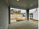 View from a covered porch looking onto a landscaped front yard and street with other homes at 4404 Emeline Way # 35, Fuquay Varina, NC 27526