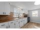 Bright kitchen with white cabinetry, modern countertops, and stainless sink at 505 N Cypress St, Wendell, NC 27591