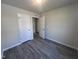 This bedroom offers neutral paint and modern gray laminate flooring throughout at 5520 Neuse View Dr, Raleigh, NC 27610