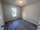 This bedroom features neutral paint and modern gray laminate flooring throughout at 5520 Neuse View Dr, Raleigh, NC 27610