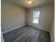 Neutral bedroom with a window and wood-look flooring at 5520 Neuse View Dr, Raleigh, NC 27610