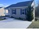Well-maintained home featuring blue shutters, gray siding, and a freshly poured concrete driveway at 5520 Neuse View Dr, Raleigh, NC 27610
