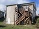 View of the house featuring a wooden staircase leading to the second level and a side door entry at 5520 Neuse View Dr, Raleigh, NC 27610