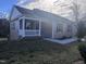 Inviting home with a cozy front porch, gray siding, and a well-manicured front lawn at 5520 Neuse View Dr, Raleigh, NC 27610