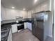 Updated kitchen features stainless steel appliances, granite countertops, and white cabinets at 5520 Neuse View Dr, Raleigh, NC 27610