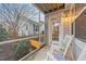 Comfortable screened-in porch with rocking chairs, overlooking a landscaped yard with a white picket fence at 5618 Wade Park Blvd, Raleigh, NC 27607
