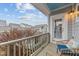 Balcony with wicker chairs and blue cushions, offering a view of the neighborhood and a cloudy sky at 5618 Wade Park Blvd, Raleigh, NC 27607