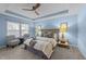 Bright bedroom featuring a tray ceiling, neutral decor, carpeted floor, and decorative lamps on each bedside table at 5618 Wade Park Blvd, Raleigh, NC 27607