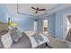 Bedroom with neutral walls and carpet, tray ceiling, and a glimpse into the bathroom and adjacent rooms at 5618 Wade Park Blvd, Raleigh, NC 27607