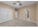 Spacious bedroom featuring neutral paint, carpet flooring, ceiling fan, and double door closet for ample storage at 5618 Wade Park Blvd, Raleigh, NC 27607