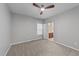 Well-lit bedroom with a ceiling fan, carpeted flooring, and a view into an ensuite bathroom, providing convenience at 5618 Wade Park Blvd, Raleigh, NC 27607