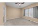 Cozy bedroom with carpet, a ceiling fan, a large window, and neutral walls, creating a relaxing atmosphere at 5618 Wade Park Blvd, Raleigh, NC 27607